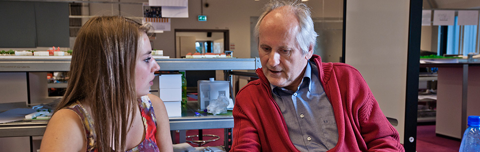 Young worker and older working talking