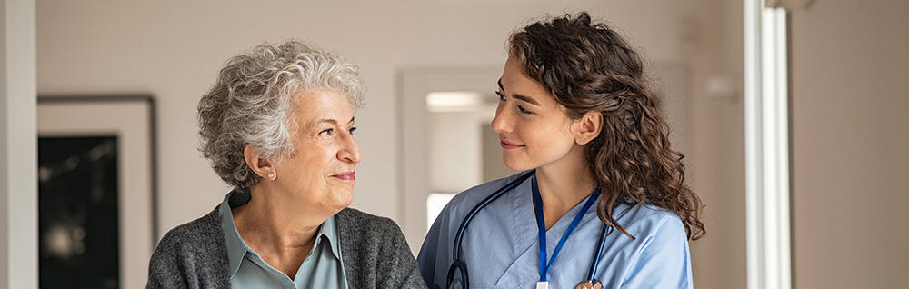 Elderly woman with a health worker.