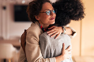 Women colleagues hugging