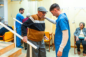 Healthcare worker helping a man