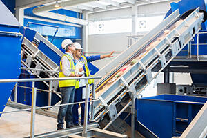 Workers talking in recycling center