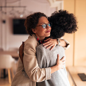 Women colleagues hugging