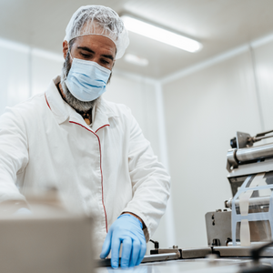 Experienced middle age man working in fresh meet processing plant.
