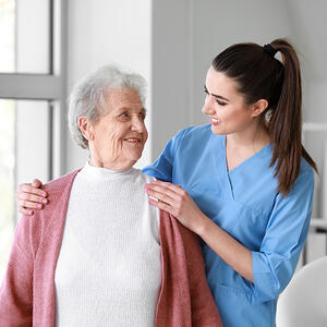 Medical worker with senior woman in nursing home