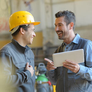 Workers talking at a factory