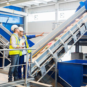 Workers talking in recycling center