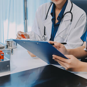 Medical workers analysing blood test results